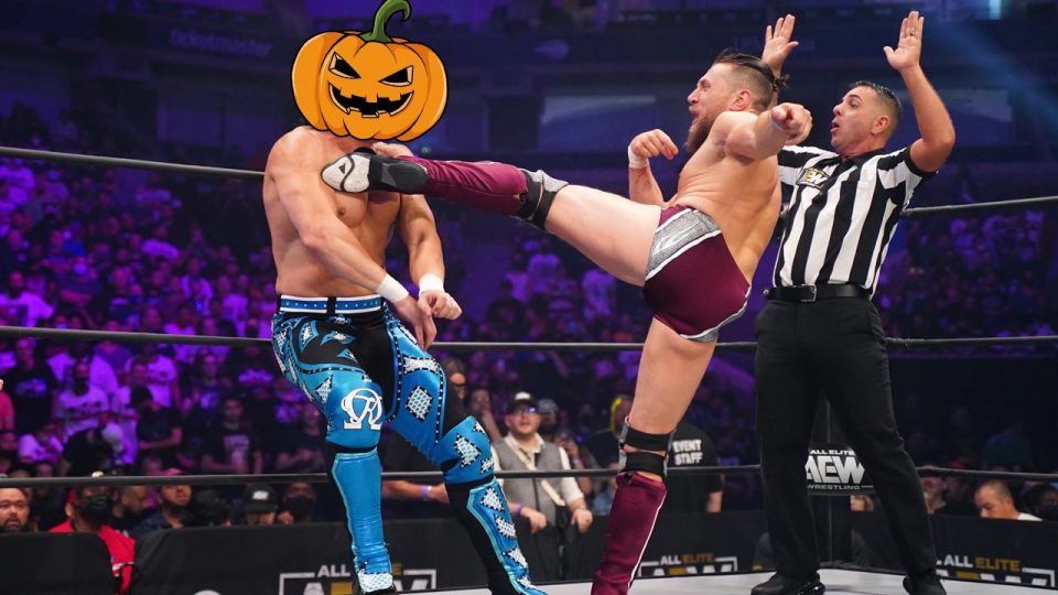 Bryan Danielson kicking Kenny Omega in an AEW ring. Omega has a Halloween pumpkin Photoshopped over his face